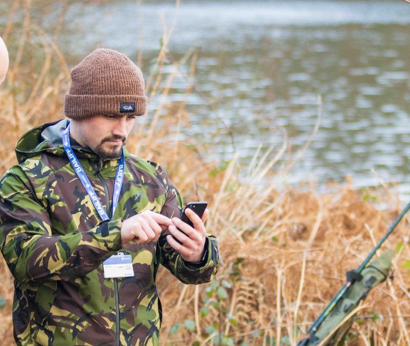 Bailiff verifying an angling membership on the bank using Clubmate’s fishing club management software.