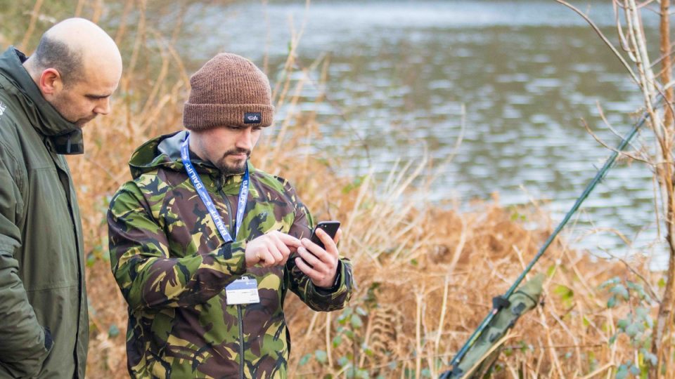 Bailiff verifying an angling membership on the bank using Clubmate’s fishing club management software.