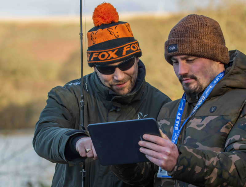 Bailiff checks an angler’s membership details on the Clubmate App to help prevent illegal fishing.