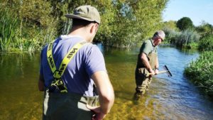Two anglers in the River Nene as part of PDAA work to improve barbel habitats