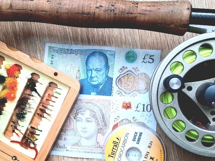 £15 and various tackle and rods on a table