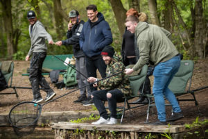 group of anglers collecting a catch in a recent tackling minds social event